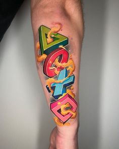 a man's arm with colorful lettering on it and an orange snake coming out of the letters