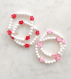 I ❤️ LOVE! The sweetest candy heart bead bracelets. Choose between pink or red hearts. Or a mix! All pieces include 14k gold or silver plating. All bracelets are FINAL SALE as these are custom orders. Please double check your bracelet size and consider the additional ½ inch increase for optimal comfort fit. CARE INSTRUCTIONS: -Avoid contact with water to improve longevity. -Roll bracelets onto your wrist to avoid over stretching. -If you are ordering a piece for a child, ALWAYS supervise while w White Hypoallergenic Bracelets As Gift, Hypoallergenic White Bracelets As Gift, Heart Beads Friendship Bracelet For Valentine's Day, Personalized Cute Bracelets For Valentine's Day, Cute Name Bracelet For Valentine's Day Gift, Sweet Personalized Bracelets As Gift, Heart Beads Name Bracelet For Valentine's Day, Personalized Sweet Bracelets As Gift, Playful Personalized Bracelets For Mother's Day