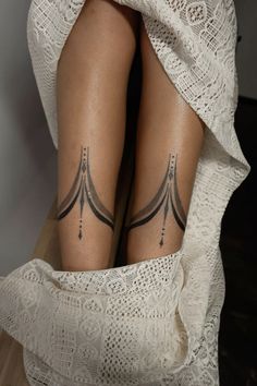 a woman's legs with tattoos on them