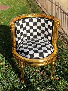 a black and white checkered chair sitting in the grass