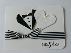 a wedding card with a black and white bow tie on the front, and a heart in the back