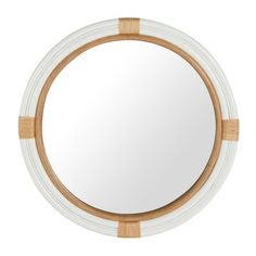 a round mirror with bamboo trim around it