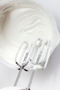 a whisk is being used to make whipped cream