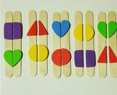 popsicles with different shapes and colors are arranged in the shape of hearts on sticks