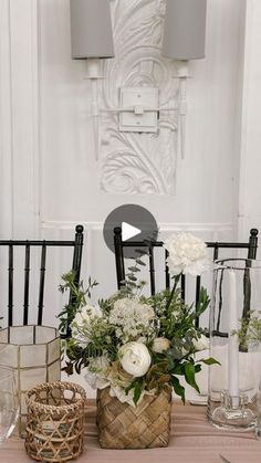 a table topped with vases filled with white flowers