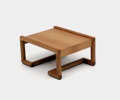 a small wooden table sitting on top of a white floor