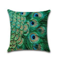 a green and blue pillow with lots of peacock feathers on it's front side