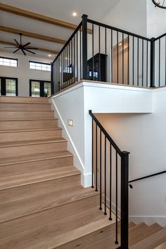 there is a clock that is on the wall next to the stairs in this house