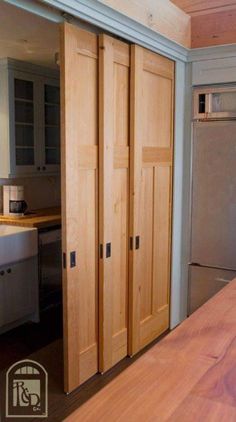 a kitchen with wooden cabinets and stainless steel refrigerator freezer next to an island counter