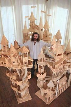 a man standing in front of a fake castle made out of wooden planks with the caption like view profile send as message