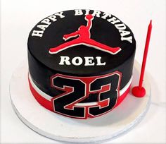 a black and red birthday cake with the number 23 on it