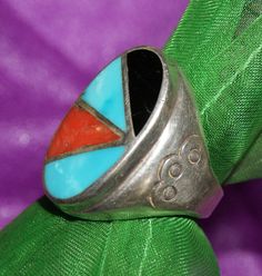 Old Pawn Navajo Ring.  Hand wrought c1960's by a seasoned silversmith.  Acquired from New Mexico Trading Co. This is a heavy sterling channel inlay of turquoise, coral, jet. Unmarked sterling silver. SIZE:   8 - 8.25 FACE:   1" X 5/8" WEIGHT:   26.9 Grams FREE WORLDWIDE SHIPPING No Returns. No Refunds. Proceeds support animals rescued from native reserves by Volunteers & Vets for almost 2 decades. No more chains, cold, hunger or further misery. All spayed/neutered to halt over-population. Thank you for your support. FOR THE LOVE OF ANIMALS 'The world is a dangerous place, not because of those that do evil, but because of those who look on and do nothing.'  -Albert Einstein Retro Handmade Oval Jewelry, Vintage Multi-stone Collectible Jewelry, Vintage Multicolor Oval Jewelry, Retro Turquoise Jewelry, Vintage Turquoise Multi-stone Jewelry, Vintage Multi-stone Turquoise Jewelry, Retro Round Turquoise Jewelry, Vintage Sterling Silver Rings With Inlay, Vintage Sterling Silver Turquoise Ring With Inlay