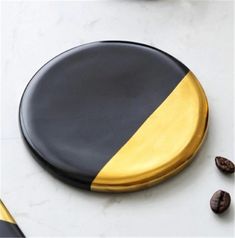 two black and gold plates with coffee beans