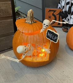 two pumpkins with skeletons in them and a sign that says help on the front