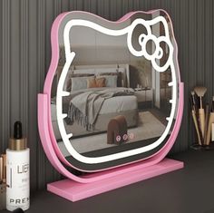 a hello kitty mirror sitting on top of a table