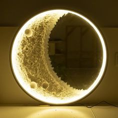 an illuminated mirror reflecting the moon in it's reflection