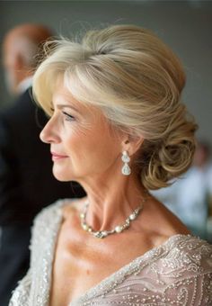 an older woman in a wedding dress looking off to the side with her eyes closed