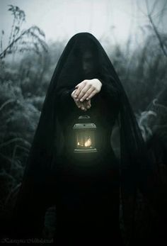 a person with a lantern in their hand