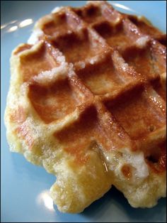 a waffle is sitting on a plate with syrup