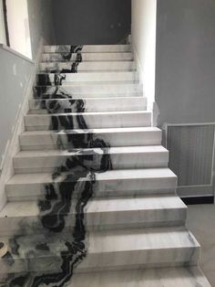 marble stairs with black and white designs on them