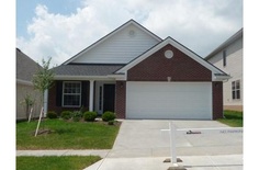 a house with two garages in the front and one on the other side that is empty