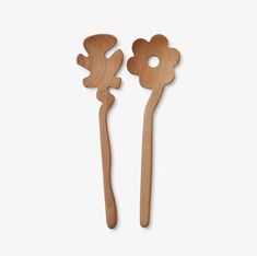 two wooden utensils with flower designs on the handles, one is made out of wood