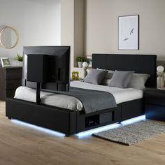 a bed that has some lights on the headboard and foot board in front of it