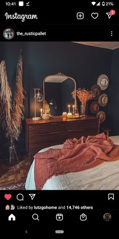 a bedroom with a bed, dresser and mirror on the wall next to each other