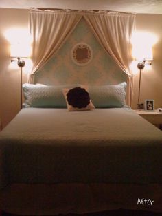 a bedroom with a bed and two lamps on either side of the headboard,