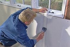 a man is painting the wall in his house