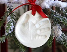 a handprint ornament hanging from a christmas tree