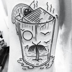 a black and white photo of a tattoo with a drink in the shape of a face