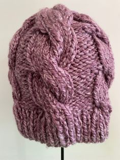 This adult sized purple winter hat is perfect to keep you warm and cozy this winter. Beautiful cables wrap from crown down this hat for a full 360.  Soft acrylic yarn was used for easy care. Machine wash and tumble dry.  Designed by Tonga of Pink Plumeria Knits  Made it a Smoke Free Home Machine wash delicate Tumble dry low Knit Coaster, Pink Plumeria, Wool Cowl, Tonga, Skull Cap Beanie, Chunky Yarn, Winter Hat, Skull Cap, Hat Sizes