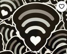 a bunch of wifi stickers sitting on top of some kind of black and white