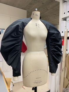 a mannequin with a black jacket on it