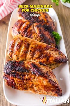 two pieces of grilled chicken on a plate with broccoli in the background