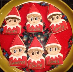 there are seven cookies with the names of people on them in front of a christmas tree