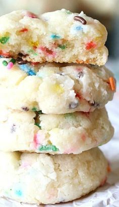 three cookies with sprinkles stacked on top of each other