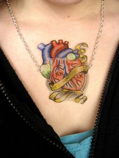 a woman with a heart tattoo on her chest