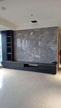 an empty living room with marble walls and flooring