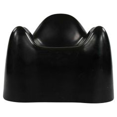 a black plastic chair that is shaped like a cat's head on a white background