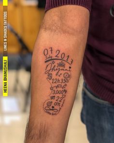 a man with a tattoo on his arm that has the date and year in it