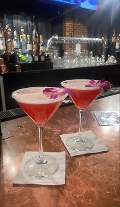 two martinis sitting on top of a bar