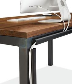 a computer monitor sitting on top of a wooden desk next to a keyboard and mouse