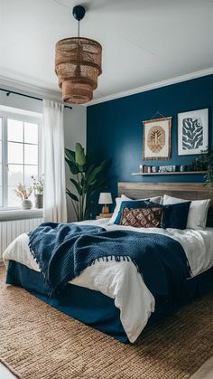 a bedroom with blue walls and white bedding in the center, along with an area rug on the floor