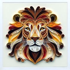 an intricately designed paper art piece with a lion's head in the center