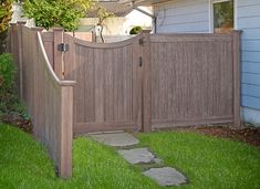 a wooden fence in front of a house