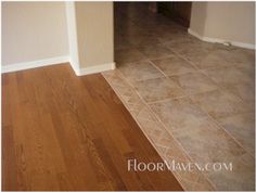 an empty room with hard wood flooring and tile