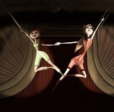 two women are suspended on strings in front of a stage curtain, one is wearing green and the other is red