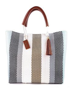 Introducing the Hannah Tote Bag - Marbella! Handwoven with luxury in mind, this tote bag is lined for durability and features elegant leather handles. Make a statement with this beautifully crafted bag that combines style and functionality. Perfect for any occasion! Details & Dimensions Handwoven and Lined Durable leather top handles One interior zipper pocket Two interior side pockets Fits a 16" laptop Magnetic closure 15" W (38cm) x 13" H (33cm) Top Handles Drop 9" Luxury Sustainable, Crafted Bag, Luxury Tote Bags, Purse Crafts, Sustainable Bag, Upcycled Leather, Handmade Tote, Tote Bags Handmade, Chic Accessories